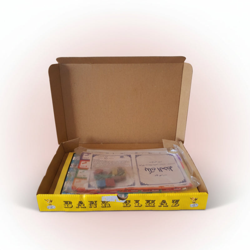 Open cardboard box with printed materials on a wooden surface