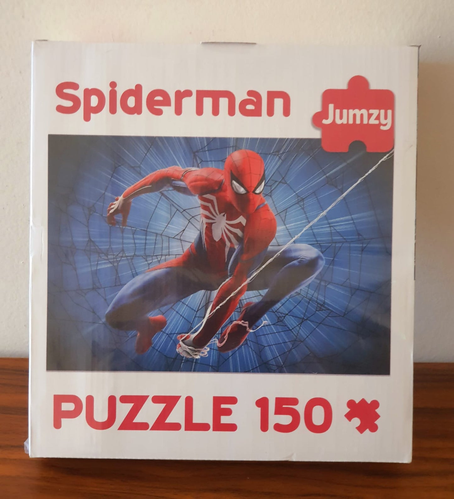 Spiderman puzzle box with Jumzy branding on a wooden surface