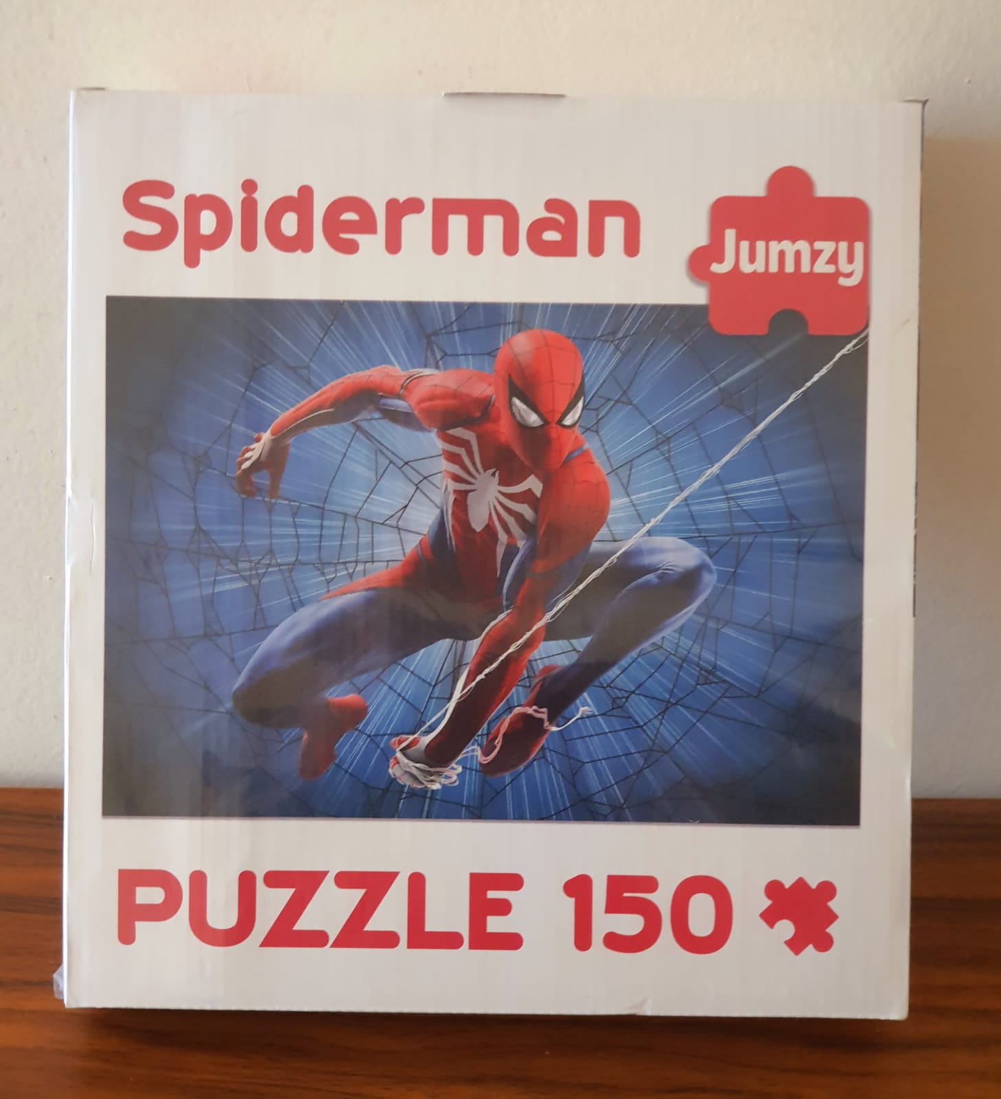 Spiderman puzzle box with Jumzy branding on a wooden surface